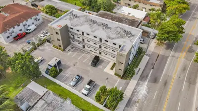 an overhead view of a large white building at Renzzi Wynwood Apartments in Miami