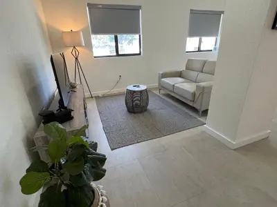 a living room with a couch and a television at Renzzi Wynwood Apartments in Miami