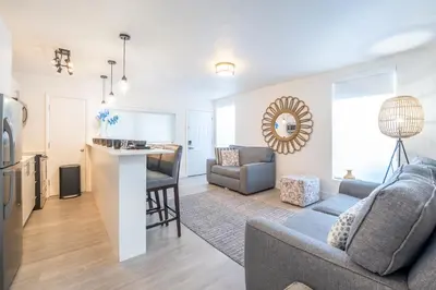 a living room and kitchen with a couch and a table at PRAIA Hotel Boutique & Apartments Miami Beach in Miami Beach
