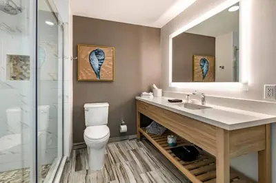 a bathroom with a toilet and a sink and a shower at Cambria Hotel Fort Lauderdale Beach in Fort Lauderdale