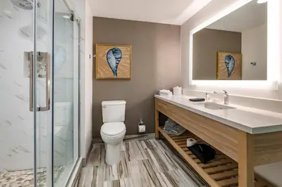 a bathroom with a toilet and a sink and a shower at Cambria Hotel Fort Lauderdale Beach in Fort Lauderdale