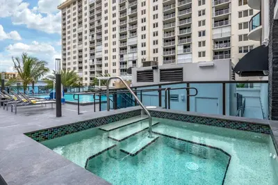 a swimming pool with stairs and a building at Cambria Hotel Fort Lauderdale Beach in Fort Lauderdale