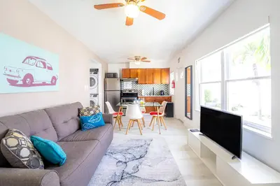 a living room with a couch and a flat screen tv at PRAIA Hotel Hollywood in Hollywood