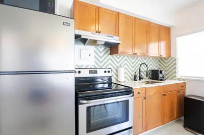 a kitchen with a refrigerator and a stove at PRAIA Hotel Hollywood in Hollywood
