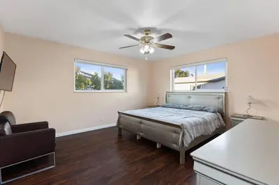 a bedroom with a bed and a ceiling fan at Tranquil Retreat with HEATED POOL Minutes to the Beach in Dania Beach