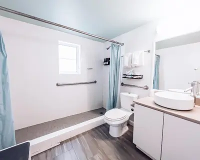 a bathroom with a toilet and a sink and a shower at Aqua Hotel in Fort Lauderdale
