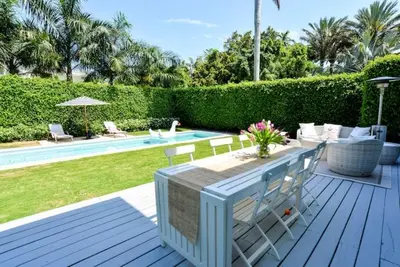 a patio with a table and chairs next to a pool at Villa Naomi - Luxury Design New Home in Miami