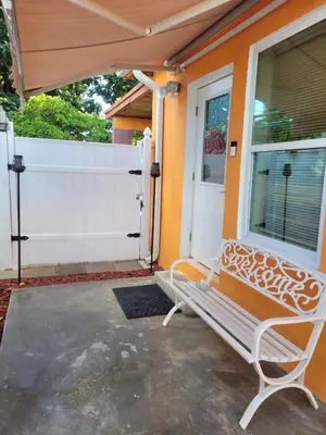 a white bench sitting in front of a house at Welcome Heart and Reliable Heart Vacation Houses in Miami
