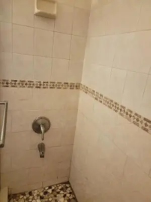 a bathroom with a shower with a tiled floor at Welcome Heart and Reliable Heart Vacation Houses in Miami