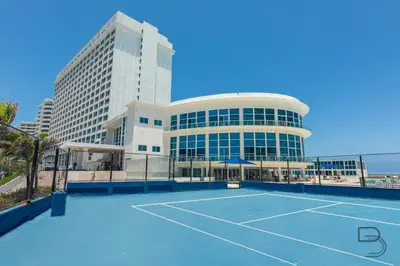 a tennis court in front of a building at Girasole Rentals Suites in Miami Beach