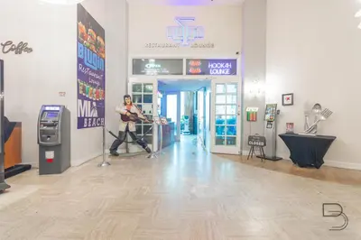 a man is playing a guitar in a store at Girasole Rentals Suites in Miami Beach