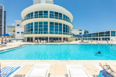 a swimming pool in front of a building at Girasole Rentals Suites in Miami Beach