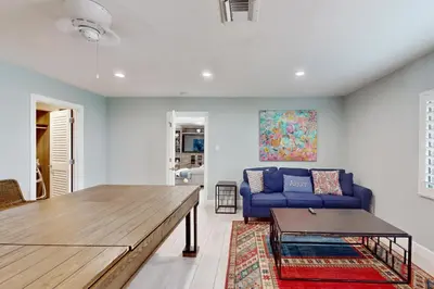 a living room with a blue couch and a table at Middle River Lookout in Fort Lauderdale