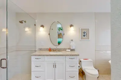 a bathroom with a toilet and a sink and a mirror at Middle River Lookout in Fort Lauderdale