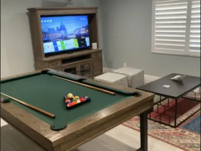 a living room with a pool table and a tv at Middle River Lookout in Fort Lauderdale