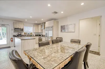 a kitchen and dining room with a table and chairs at Designer Delight in Fort Lauderdale