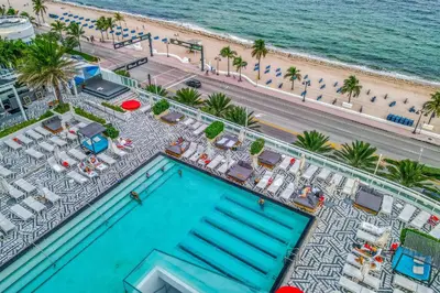 an overhead view of a swimming pool and the beach at The Residency at Fort Lauderdale in Fort Lauderdale