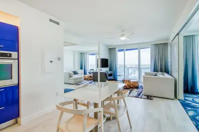 a kitchen and living room with a table and chairs at The Residency at Fort Lauderdale in Fort Lauderdale