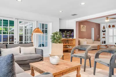 a living room with a couch and chairs and a table at NEWLY RENOVATED POOL, HOT TUB, & EPIC BACKYARD in Fort Lauderdale