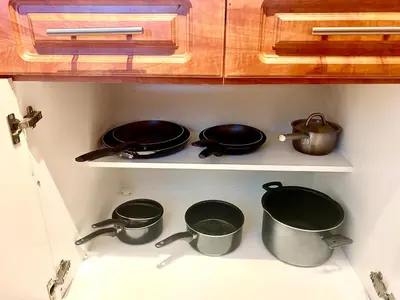 a kitchen with pots and pans on a shelf at Large luxurious direct ocean front Penthouse or Deluxe 1 BR ocean front condo-Beach access- Free parking- Remodeled in Miami Beach