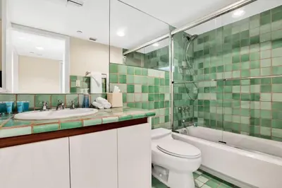 a bathroom with a toilet and a tub and a sink at NEW Amazing large 3BR direct oceanfront Penthouse On Ocean Drive!! in Miami Beach