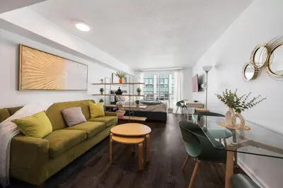 a living room with a couch and a table at Studios in Brickell with Pool, Gym, free parking and Game Room in Miami