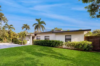 a house with a lawn in front of it at Mid-Century Modern Oasis in Miami