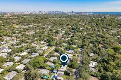 an aerial view of a neighborhood with a city in the background at Mid-Century Modern Oasis in Miami