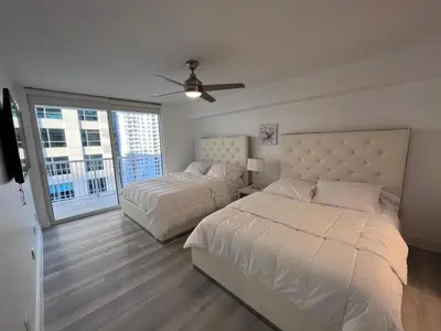 a bedroom with two beds and a ceiling fan at Luxury 1BD Apt in Downtown Brickell free parking in Miami