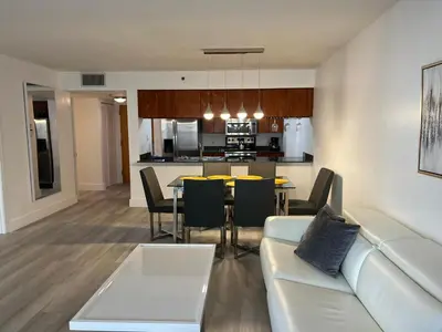 a living room and kitchen with a couch and a table at Luxury 1BD Apt in Downtown Brickell free parking in Miami