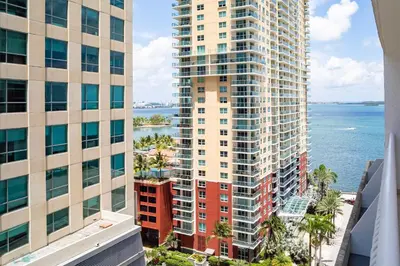 an aerial view of two tall buildings and the ocean at Luxury 1BD Apt in Downtown Brickell free parking in Miami