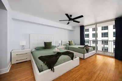 a bedroom with two beds and a ceiling fan at 1Bd Apt with Free Parking and Amazing View in Miami