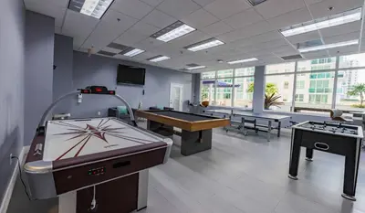 a room with two ping pong tables and a pool table at 1Bd Apt with Free Parking and Amazing View in Miami