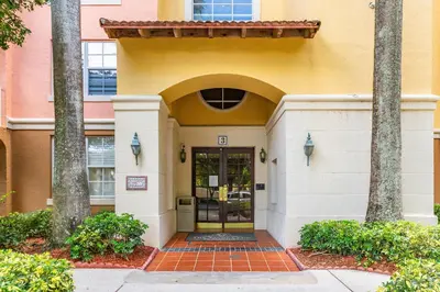 a front door of a building with palm trees at Yacht Club Miami Suite 2 Bedroom and 2 Bathroom With Baby Crib & Free Parking in Miami
