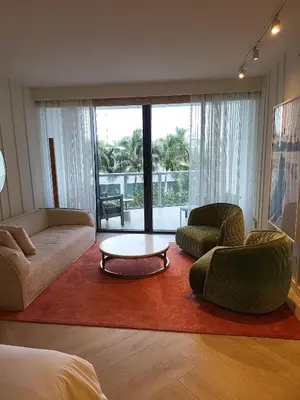 a living room with a couch and chairs and a table at Residences Suite South Beach in Miami Beach