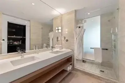 a large bathroom with two sinks and a shower at Residences Suite South Beach in Miami Beach