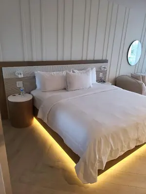 a large white bed in a hotel room with lights at Residences Suite South Beach in Miami Beach