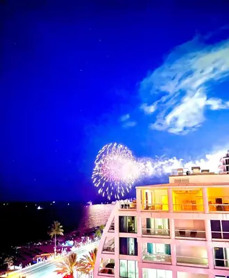 a firework display in the sky above a building at The Atlantic Hotel & Spa Condo in Fort Lauderdale