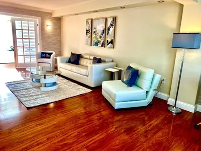 a living room with a couch and two chairs at Deluxe waterfront one bedroom apartment with Miami Skyline view, free parking 5 mins drive to Miami Beach in Miami Beach