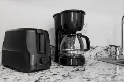 a coffee maker and a toaster on a kitchen counter at Sunset Inn-South Miami in South Miami