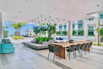 a large dining room with a large wooden table and chairs at LUXURY 1 BDRM/1B APT IN MIAMI DESIGN DISTRICT AREA in Miami