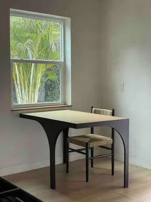 a table and a chair in front of a window at Casa Terra Lumi - at lumicollection in Fort Lauderdale