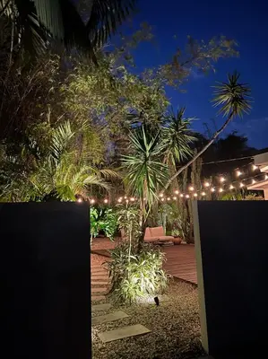 a garden at night with a string of lights at Casa Terra Lumi - at lumicollection in Fort Lauderdale