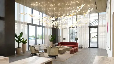 an office lobby with a red couch and chairs at Global Luxury Suites Miami Worldcenter in Miami