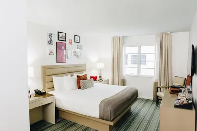 a hotel room with a bed and a desk at Uma House by Yurbban South Beach in Miami Beach