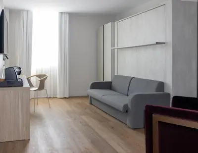 a living room with a couch and a television at Uma House by Yurbban South Beach in Miami Beach