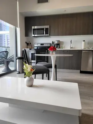 a kitchen and living room with a white counter top at Lovely Condo Unit in Miami