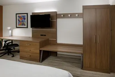 a hotel room with a desk and a television at Holiday Inn Express & Suites - Miramar by IHG in Miramar