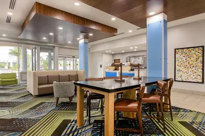 a dining room with a table and chairs at Holiday Inn Express & Suites - Miramar by IHG in Miramar