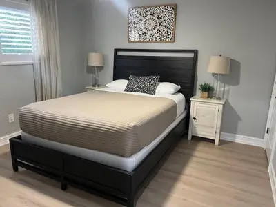 a bedroom with a large bed with a black headboard at 3 Bed - Sleeps 6 - Free Parking - 5 Mins to Beach in Hollywood